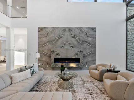 a living room with furniture and large windows