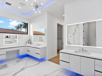 a bathroom with a sink a toilet a shower and a mirror
