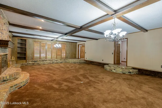 a view of an empty room with a chandelier