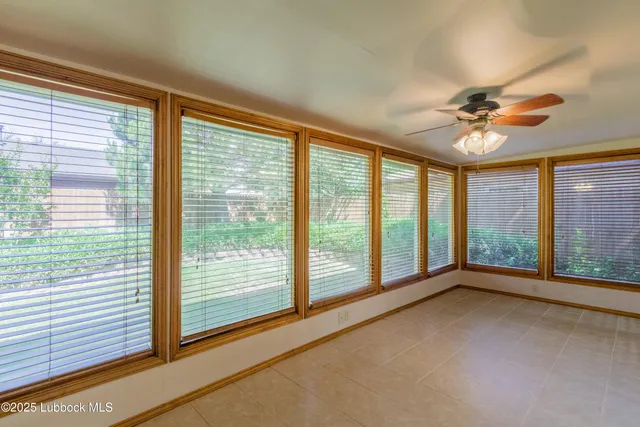 a spacious bedroom with a bed and a chandelier