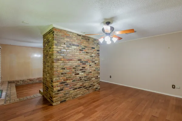 a backyard of a house with garden and outdoor seating