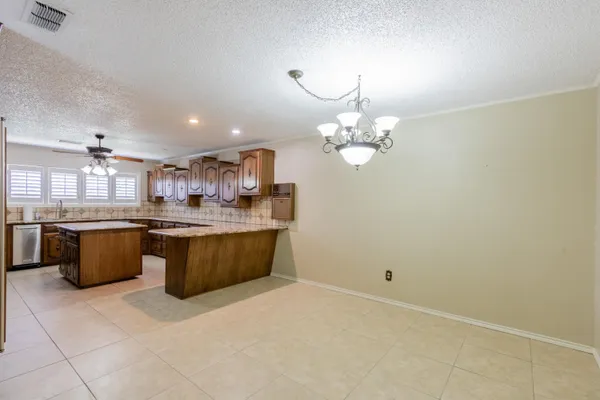 a kitchen with stainless steel appliances granite countertop a sink and a microwave
