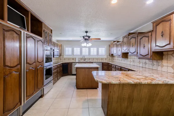 a view of an empty room with a chandelier