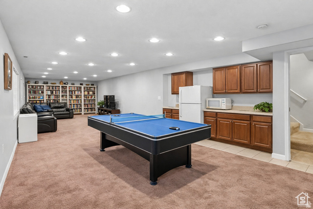7092 Cherokee Street Eagle Mountain, UT 84005 - Photo 12 of 27 Spacious lower level featuring plush carpet, extensive recessed lighting, and a built-in wet bar with cabinetry and countertop space