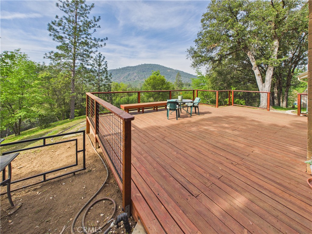 6650 Feliciana Mountain Road Midpines, CA 95345 - Photo 26 of 57 a view of a balcony with wooden floor and fence