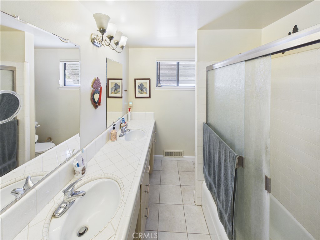 6650 Feliciana Mountain Road Midpines, CA 95345 - Photo 41 of 57 a bathroom with a granite countertop sink a mirror a shower and a bathtub
