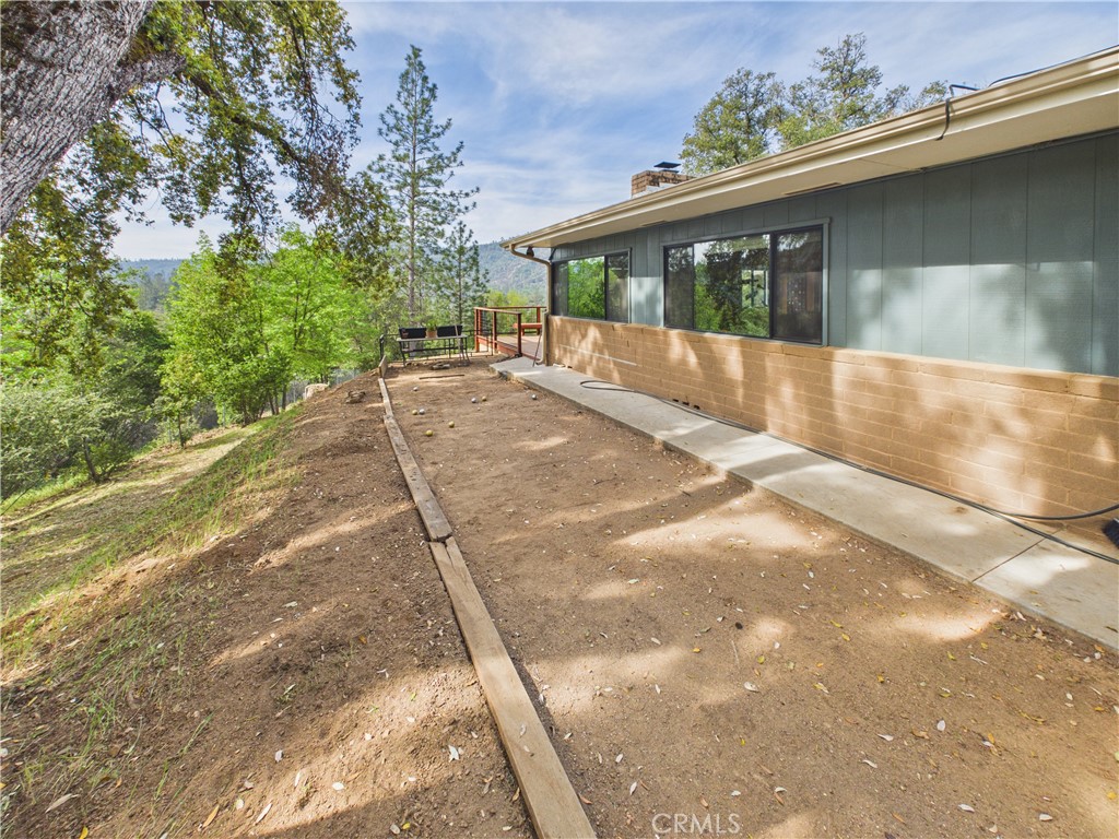 6650 Feliciana Mountain Road Midpines, CA 95345 - Photo 57 of 57 a view of a house with a yard