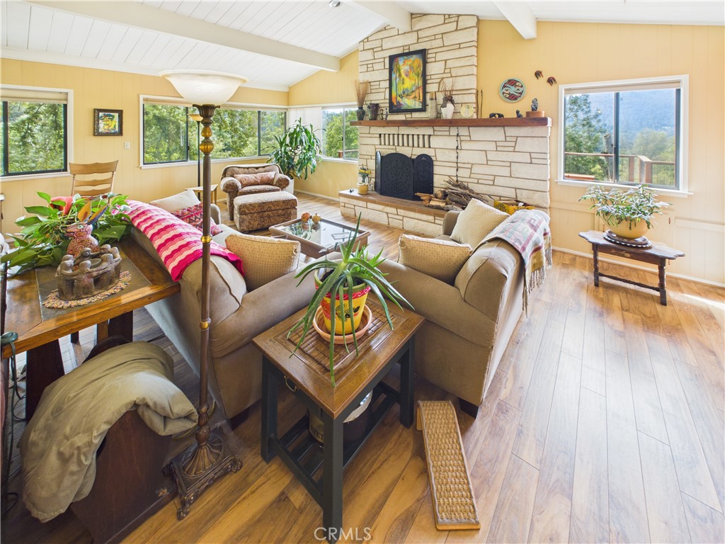6650 Feliciana Mountain Road Midpines, CA 95345 - Photo 7 of 57 a living room with furniture a fireplace and a table
