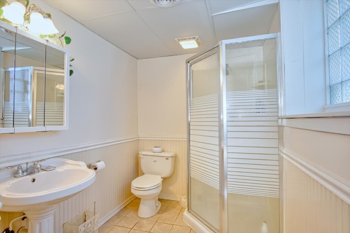 251 West Armitage Avenue Elmhurst, IL 60126 - Photo 13 of 16 a bathroom with a sink a toilet and shower