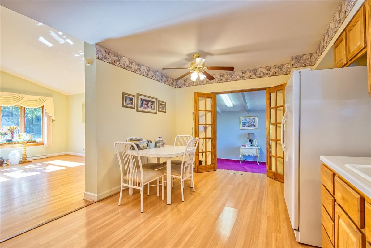 251 West Armitage Avenue Elmhurst, IL 60126 - Photo 6 of 16 a view of a dining room with furniture a chandelier and wooden floor