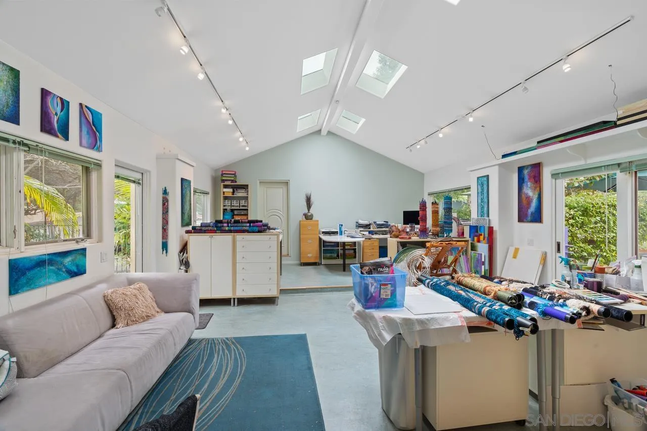 2626 Hidden Valley Road La Jolla, CA 92037 - Photo 18 of 54 a living room with furniture and a flat screen tv