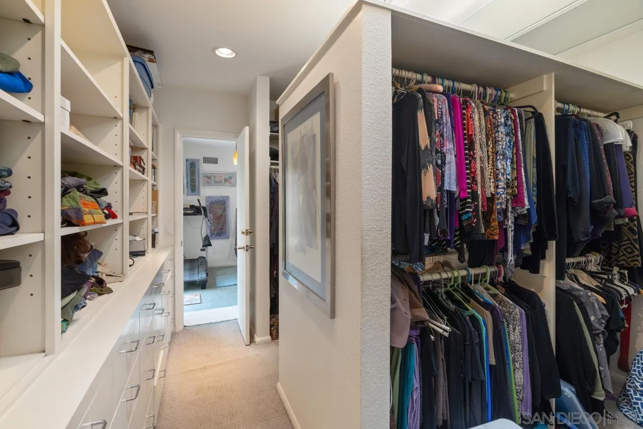2626 Hidden Valley Road La Jolla, CA 92037 - Photo 20 of 54 a view of walk in closet with clothes and shoes