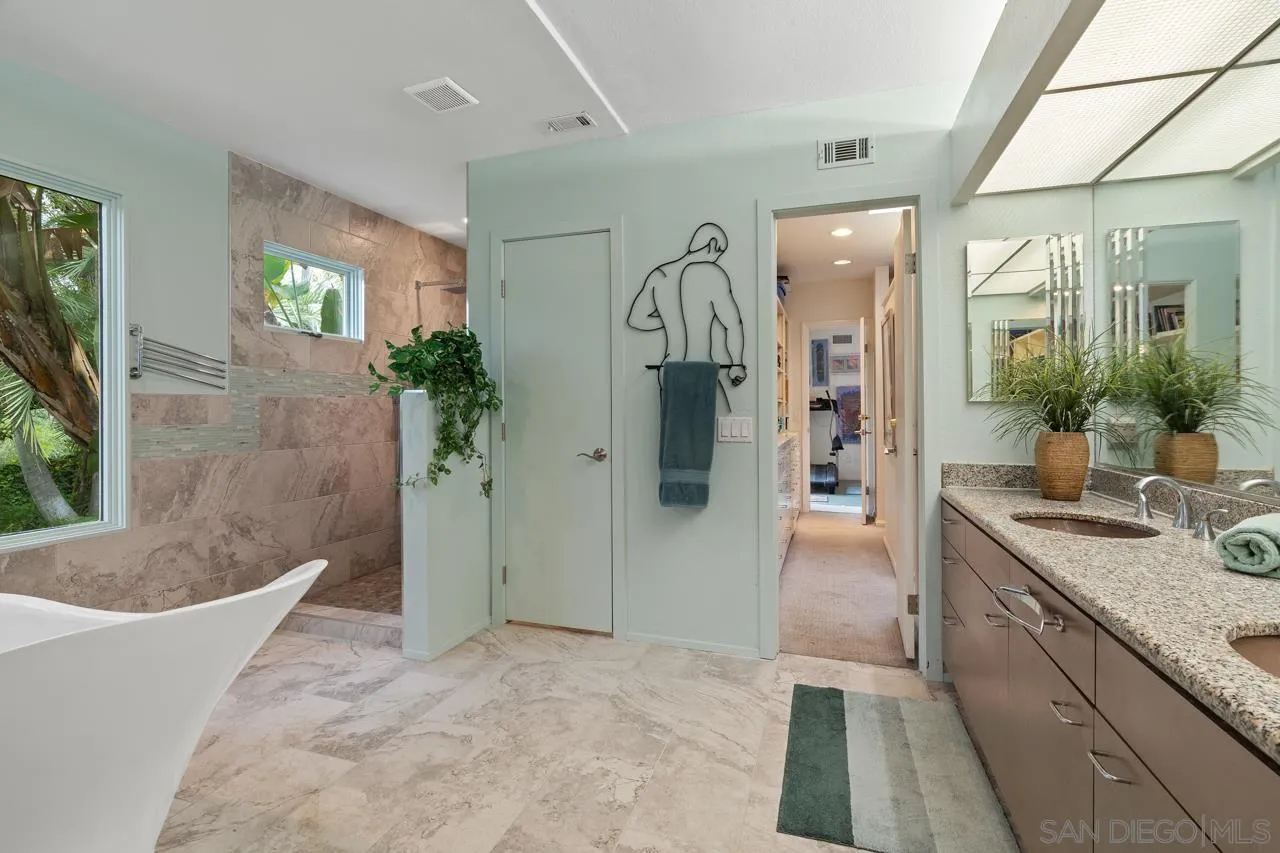 2626 Hidden Valley Road La Jolla, CA 92037 - Photo 21 of 54 a bathroom with a granite countertop tub sink and mirror