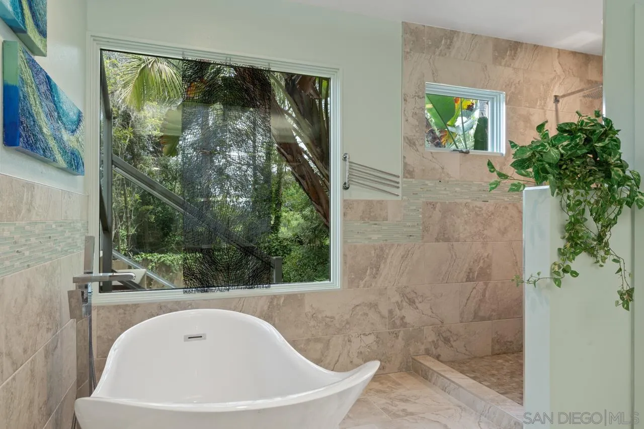 2626 Hidden Valley Road La Jolla, CA 92037 - Photo 22 of 54 a bathroom with a bathtub and shower