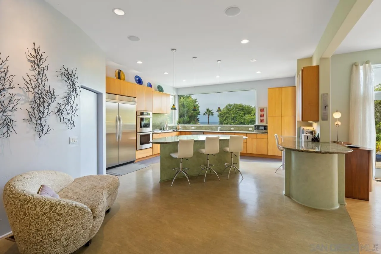2626 Hidden Valley Road La Jolla, CA 92037 - Photo 35 of 54 a living room with furniture a large window with kitchen view
