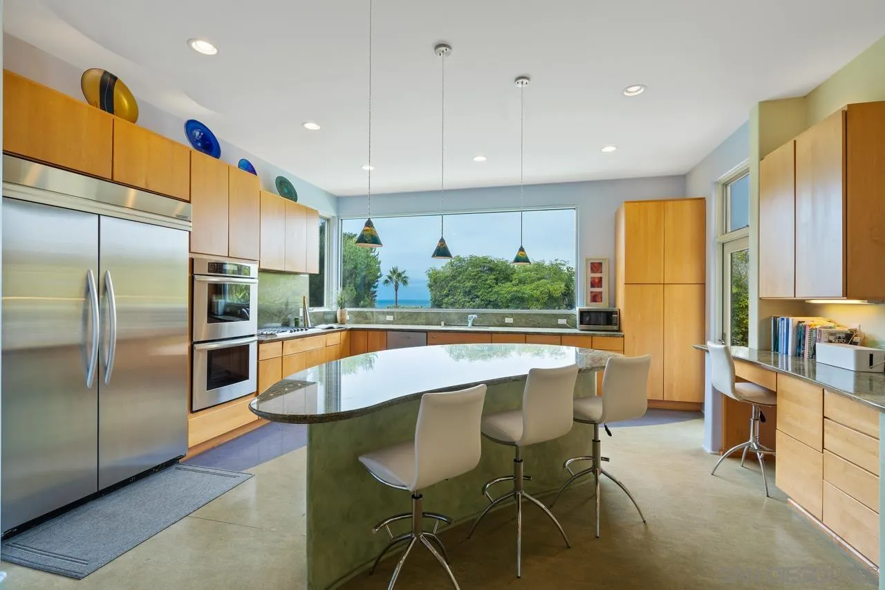 2626 Hidden Valley Road La Jolla, CA 92037 - Photo 37 of 54 a large kitchen with stainless steel appliances a large counter top