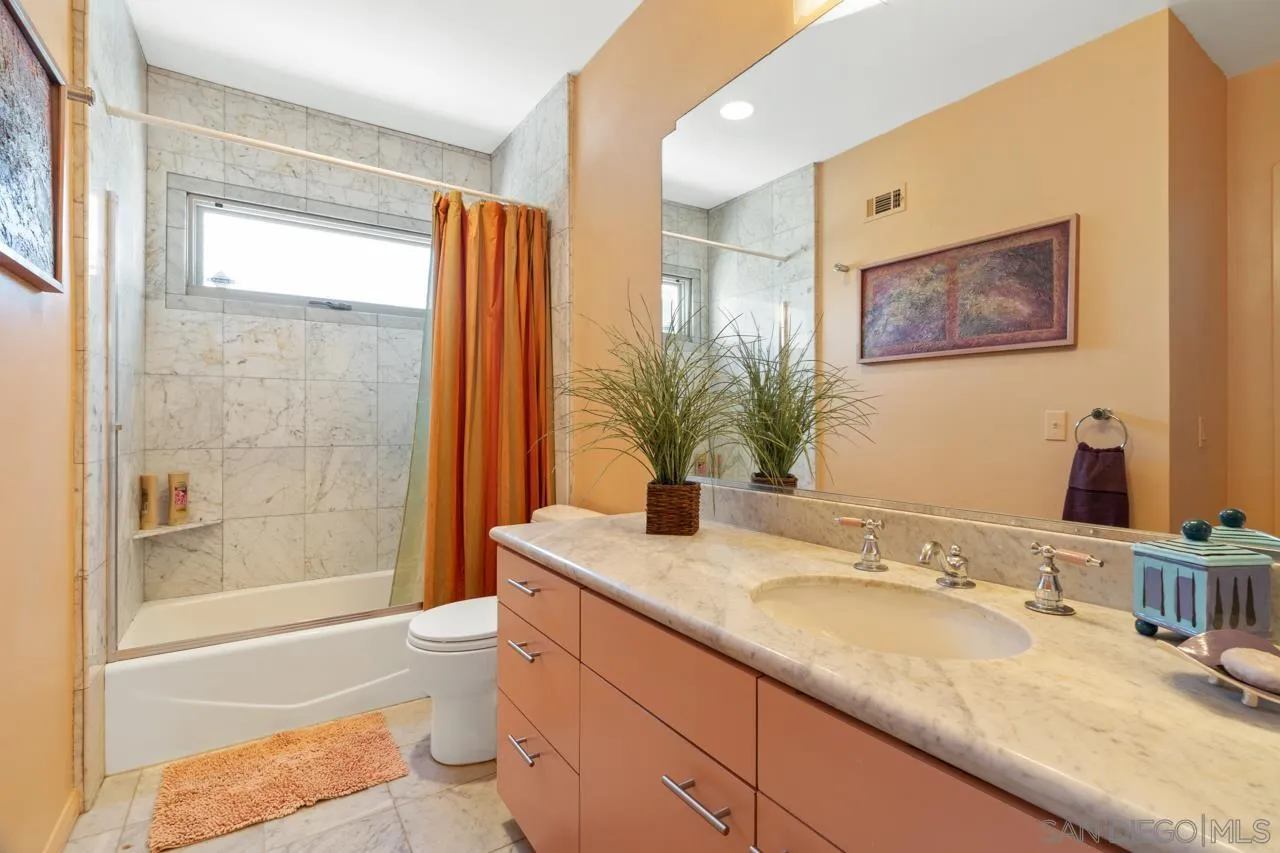 2626 Hidden Valley Road La Jolla, CA 92037 - Photo 46 of 54 a bathroom with a granite countertop sink toilet and shower