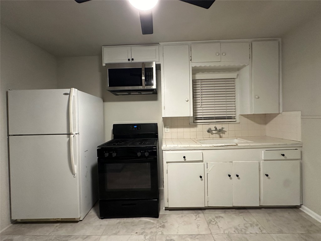 2721 Napoleon Street Houston, TX 77004 - Photo 5 of 19 a kitchen with a refrigerator stove and sink