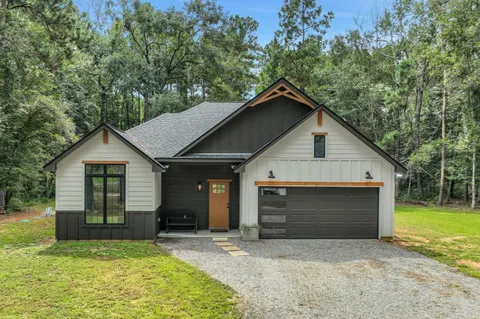 a view of house with yard and garage