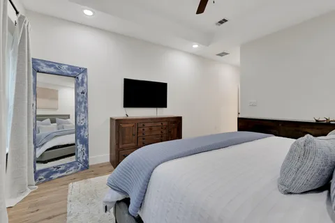 a bedroom with a bed and a television