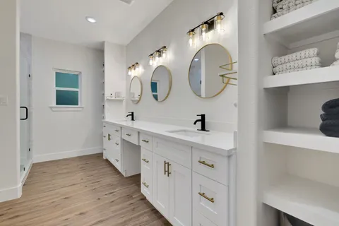 a spacious bathroom with a double vanity sink and a mirror