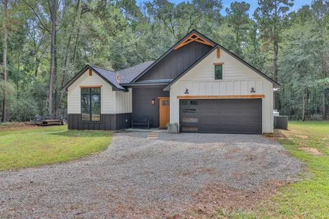 a front view of house with yard and trees