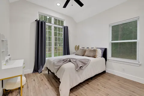 a bedroom with a bed and a window