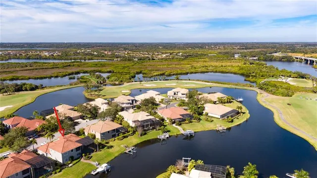 a view of a house with a yard and lake view