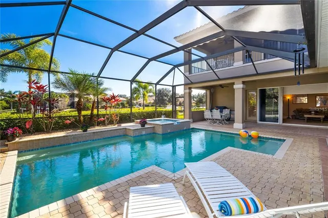 a large kitchen with stainless steel appliances and a large counter top