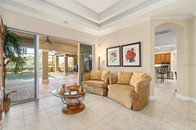 a dining room with furniture a large window and a chandelier