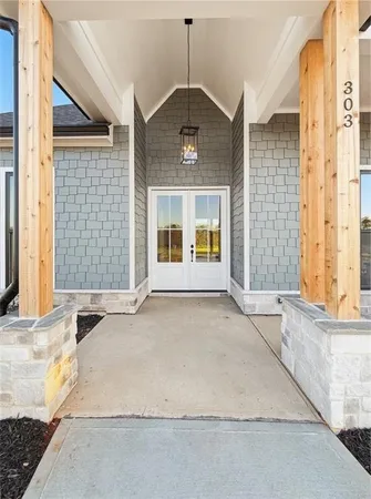 a large living room with kitchen island stainless steel appliances wooden floor and a large window