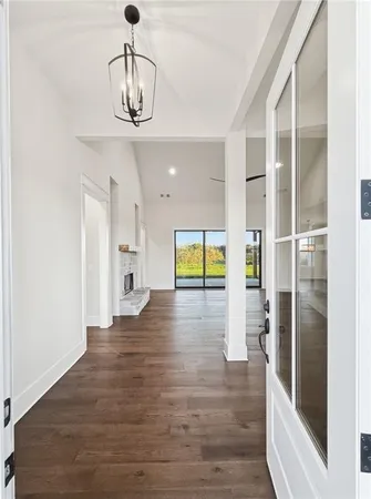 a view of a livingroom with wooden floor and a ceiling fan