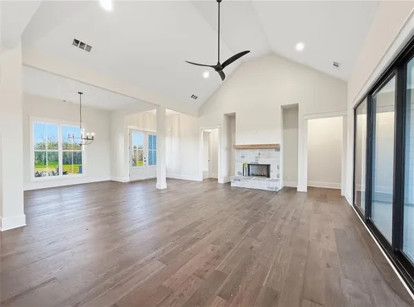 a view of a room with racks on the wall and wooden floor