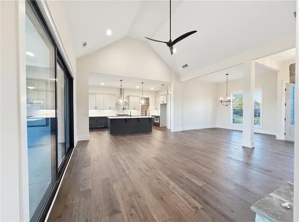 an empty room with a window and a ceiling fan