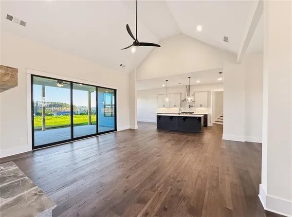 an empty room with closet and ceiling fan