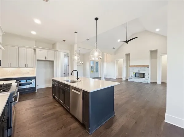 a view of a hallway with wooden floor and entryway