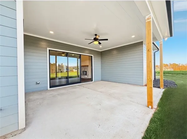 a front view of a house with yard and furniture