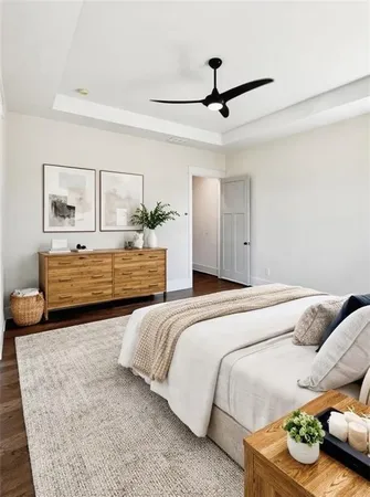 a view of an empty room with wooden floor fireplace and a window