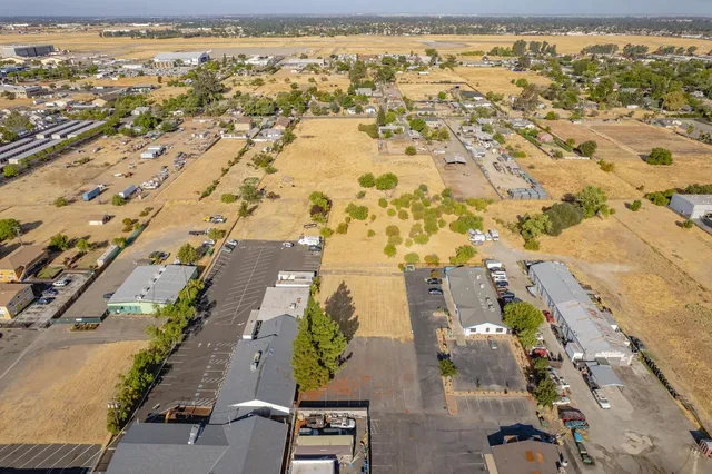 an aerial view of residential houses with outdoor space