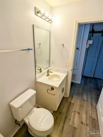 a bathroom with a sink a toilet and mirror