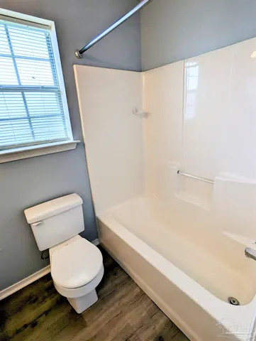 a bathroom with a toilet and a bathtub