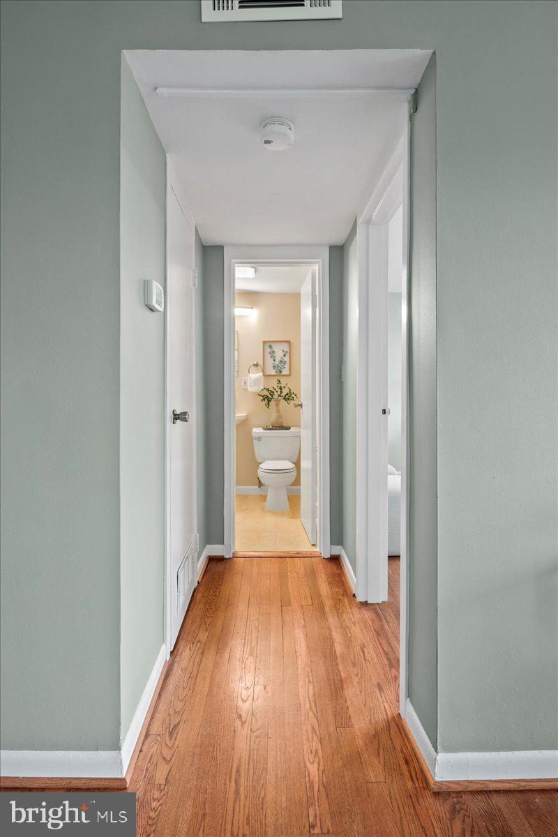 2016 North Adams Street, Unit 701 Arlington, VA 22201 - Photo 15 of 32 a view of a hallway with wooden floor and a bathroom