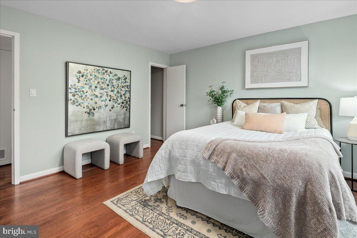 2016 North Adams Street, Unit 701 Arlington, VA 22201 - Photo 17 of 32 a bedroom with a large bed and wooden floor