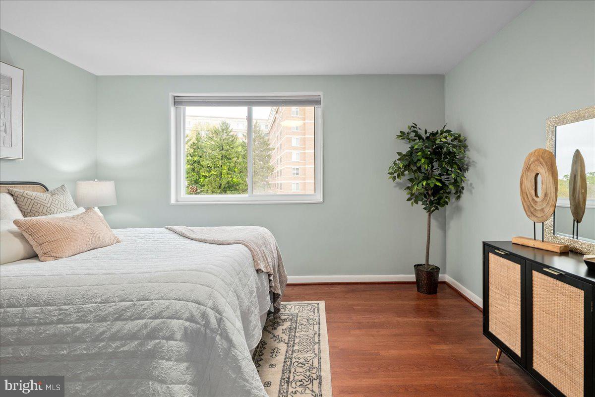 2016 North Adams Street, Unit 701 Arlington, VA 22201 - Photo 18 of 32 a bedroom with a bed and a potted plant on the dresser