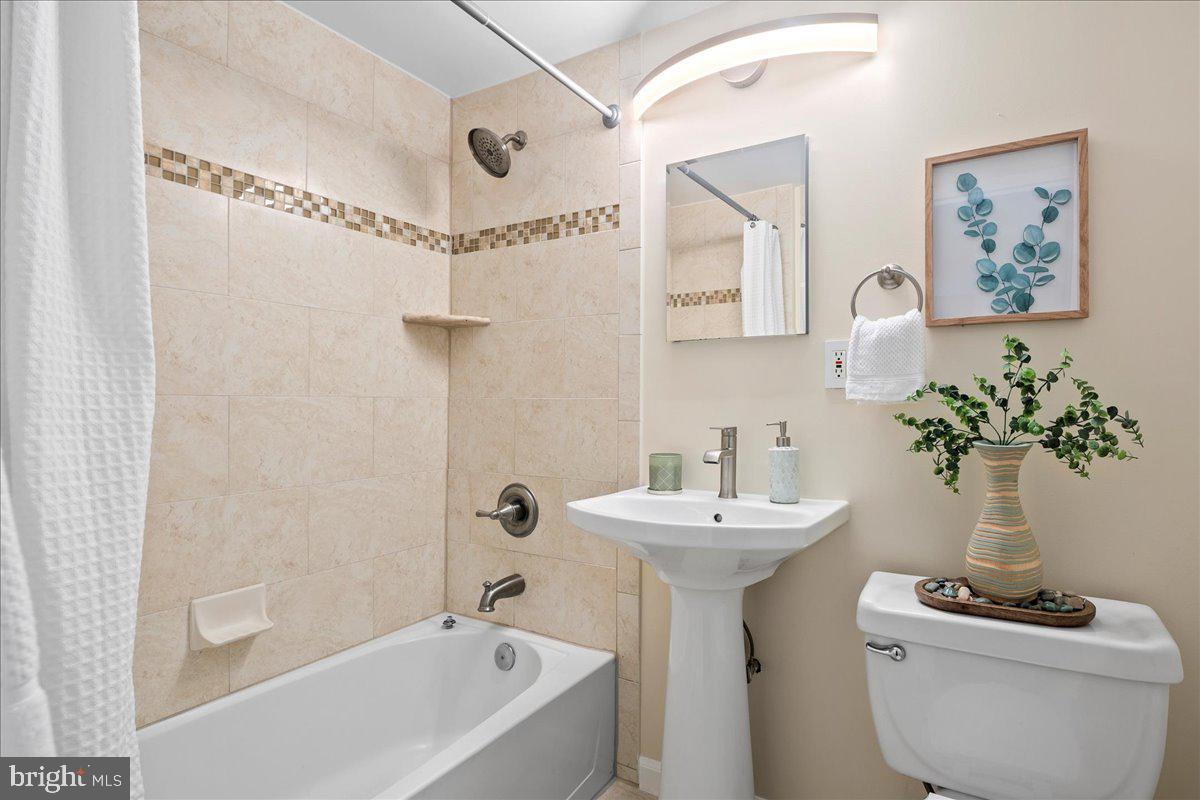 2016 North Adams Street, Unit 701 Arlington, VA 22201 - Photo 20 of 32 a bathroom with a sink toilet and a mirror
