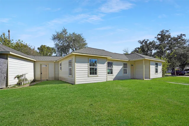 a view of a house with a yard and a garden