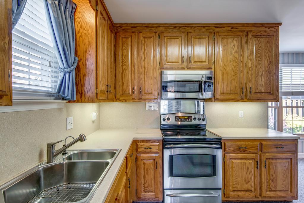 700 General George Patton Road Nashville, TN 37221 - Photo 4 of 21 a kitchen with granite countertop a sink and a stove next to a window