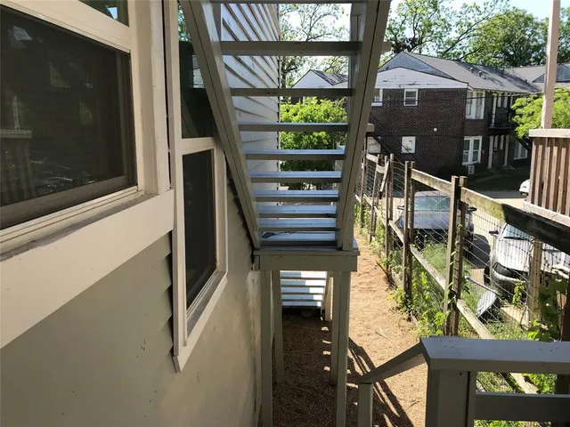 a view of a big yard with large trees