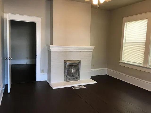 a living room with a fireplace and a window