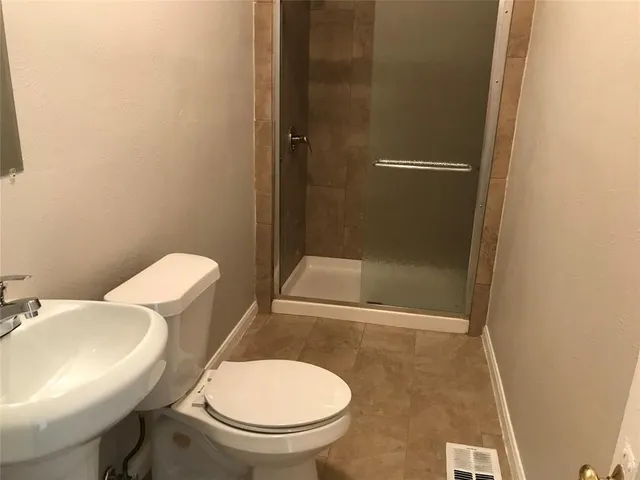 a white toilet sitting next to a bathroom sink